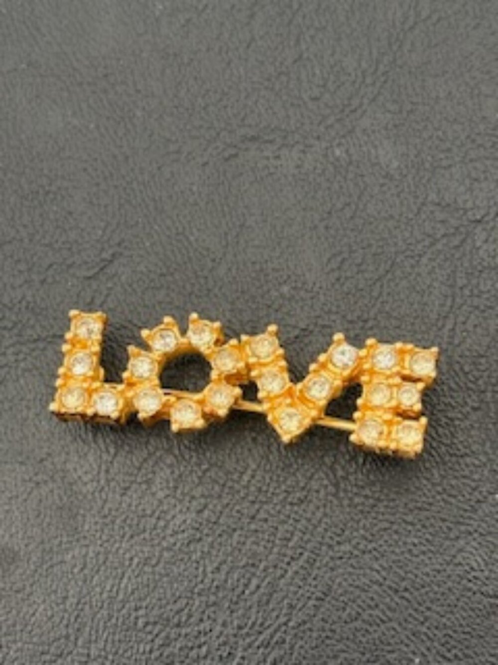 Gold tone "Love" pin-Pave rhinestone accents-Bright yellow gold over metal base